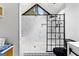 Modern bathroom features a glass-enclosed shower and decorative black and white tiling at 608 E Banks Rd, Fayetteville, GA 30214