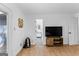 Bedroom with wooden floors, a TV, weights, and a glimpse of the stylish bathroom at 608 E Banks Rd, Fayetteville, GA 30214