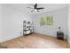Sunlit bedroom with hardwood floors, a modern ceiling fan, and a minimalist decor style at 608 E Banks Rd, Fayetteville, GA 30214