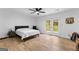 Spacious bedroom with a large bed, chair, and patio doors leading to the backyard at 608 E Banks Rd, Fayetteville, GA 30214