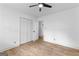 Bright bedroom with hardwood floors and ceiling fan, featuring a closet and access to other rooms at 608 E Banks Rd, Fayetteville, GA 30214