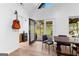 Quaint dining room with lots of natural light and yard access and a cool guitar hanging on the wall at 608 E Banks Rd, Fayetteville, GA 30214