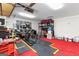 Spacious garage with red carpet, tool chests, overhead lighting, and organized shelving for storage at 608 E Banks Rd, Fayetteville, GA 30214