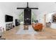 Bright open-concept living room featuring wood floors, stone fireplace, and a vaulted ceiling at 608 E Banks Rd, Fayetteville, GA 30214