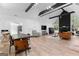 Open living space with vaulted ceilings, wood floors, stone fireplace, and large windows at 608 E Banks Rd, Fayetteville, GA 30214