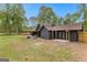 Beautiful single Gathering home showcasing backyard with mature landscaping and covered patios at 608 E Banks Rd, Fayetteville, GA 30214