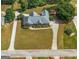 A captivating aerial view of a home displaying its circular driveway and large, landscaped yard at 103 Wisteria Way, Stockbridge, GA 30281