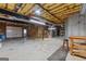 An unfinished basement with exposed ceiling, concrete floor, garage door, and wooden frame at 103 Wisteria Way, Stockbridge, GA 30281