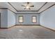 Spacious bedroom featuring a tray ceiling, ceiling fan, and two windows providing plenty of natural light at 103 Wisteria Way, Stockbridge, GA 30281