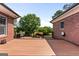 Wide shot of a wooden deck bordered by brick and a view of the yard at 103 Wisteria Way, Stockbridge, GA 30281
