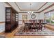 Elegant dining room with a large cabinet, chandelier, and hardwood floors that connect to the kitchen at 103 Wisteria Way, Stockbridge, GA 30281