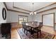 Dining room with large table, stylish chandelier, wood floors, and a view of the outdoors at 103 Wisteria Way, Stockbridge, GA 30281
