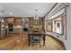 Open dining area featuring a large table, chandelier, and hardwood floors that connect seamlessly to the kitchen at 103 Wisteria Way, Stockbridge, GA 30281