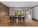 Dining area with built-in cabinets, large bay window, hardwood floors, and a contemporary chandelier at 103 Wisteria Way, Stockbridge, GA 30281