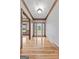 A well-lit foyer with hardwood floors and decorative glass door with wood trim throughout at 103 Wisteria Way, Stockbridge, GA 30281