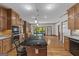 Open concept kitchen featuring an oversized island, granite countertops, and hardwood flooring at 103 Wisteria Way, Stockbridge, GA 30281