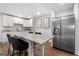 This kitchen features white cabinets, stainless steel appliances, and a marble countertop eating area at 103 Wisteria Way, Stockbridge, GA 30281