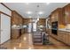 Large kitchen showcasing a granite island, custom cabinets, stainless steel refrigerator, and hardwood floors at 103 Wisteria Way, Stockbridge, GA 30281