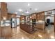 Spacious kitchen featuring custom wood cabinetry, large island, stainless steel appliances, and hardwood flooring at 103 Wisteria Way, Stockbridge, GA 30281