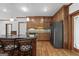 Spacious kitchen with hardwood floors, custom cabinets, a granite island, and stainless steel appliances at 103 Wisteria Way, Stockbridge, GA 30281