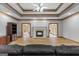 Living room with a gas fireplace and open doorways on either side with hardwood flooring throughout at 103 Wisteria Way, Stockbridge, GA 30281