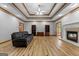 Spacious living room with a fireplace, hardwood floors, and custom built-in shelves at 103 Wisteria Way, Stockbridge, GA 30281