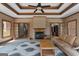 Cozy living room featuring tile floors, gas fireplace, and a centered wooden coffee table at 103 Wisteria Way, Stockbridge, GA 30281
