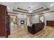 Expansive living room featuring a fireplace, hardwood floors, and tray ceiling at 103 Wisteria Way, Stockbridge, GA 30281