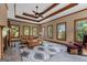 Bright living room with large windows, tray ceiling, fireplace, and comfortable seating at 103 Wisteria Way, Stockbridge, GA 30281