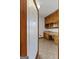 Bright pantry with wood cabinetry, countertop space, and a decorative glass door for convenient storage at 103 Wisteria Way, Stockbridge, GA 30281