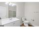 Bathroom with a white vanity, toilet, and glass-enclosed shower and tile flooring at 185 Cold Harbor Ct, Sharpsburg, GA 30277