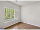 Bright bedroom featuring wood floors, fresh paint, and a large window with a wooded view at 185 Cold Harbor Ct, Sharpsburg, GA 30277