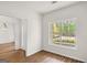 Bright bedroom featuring wood floors, fresh paint, and a large window with a wooded view at 185 Cold Harbor Ct, Sharpsburg, GA 30277