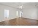Bright bedroom with wood-look floors, ceiling fan, and multiple doorways at 185 Cold Harbor Ct, Sharpsburg, GA 30277