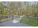 A gray wooden deck overlooks a serene view of lush greenery and tall trees at 185 Cold Harbor Ct, Sharpsburg, GA 30277