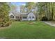 Charming single-story home with a well-manicured lawn and a welcoming red front door at 185 Cold Harbor Ct, Sharpsburg, GA 30277