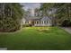 Charming single-story home with a well-manicured lawn and a welcoming red front door at 185 Cold Harbor Ct, Sharpsburg, GA 30277
