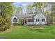 Charming single-story home with a well-manicured lawn and a welcoming red front door at 185 Cold Harbor Ct, Sharpsburg, GA 30277