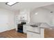 Bright kitchen featuring stainless appliances, breakfast bar, and views into living room at 185 Cold Harbor Ct, Sharpsburg, GA 30277