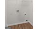 Laundry room featuring hookups, white walls, and wood-look flooring at 185 Cold Harbor Ct, Sharpsburg, GA 30277