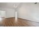 Spacious living room featuring vaulted ceiling, wood floors, and entryway to bedrooms at 185 Cold Harbor Ct, Sharpsburg, GA 30277