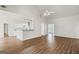 Bright living room with vaulted ceiling, wood floors, and views into the kitchen and entryway at 185 Cold Harbor Ct, Sharpsburg, GA 30277