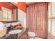 Bathroom with granite countertops, framed mirror, a shower with patterned curtains, and white plantation shutters at 230 Haynes Rd, Moreland, GA 30259
