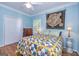 Bedroom showcasing hardwood floors, blue walls, white trim, plantation shutters and a decorative quilt at 230 Haynes Rd, Moreland, GA 30259