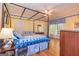 Spacious bedroom with hardwood floors, a four poster bed, and a bay window offering abundant natural light at 230 Haynes Rd, Moreland, GA 30259