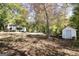 A residential property with a two-story home and a large shed, nestled on a lot surrounded by trees at 230 Haynes Rd, Moreland, GA 30259