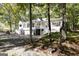 Two-story home with white siding, a charming front porch, and an attached two-car garage at 230 Haynes Rd, Moreland, GA 30259