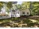 Charming two-story home with white siding, red shutters, and a welcoming front porch with ample natural light at 230 Haynes Rd, Moreland, GA 30259