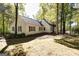 Traditional home nestled among mature trees. White exterior with red shutters at 230 Haynes Rd, Moreland, GA 30259