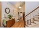 Inviting foyer boasts hardwood floors, elegant lighting, staircase, and charming decorative accents at 230 Haynes Rd, Moreland, GA 30259